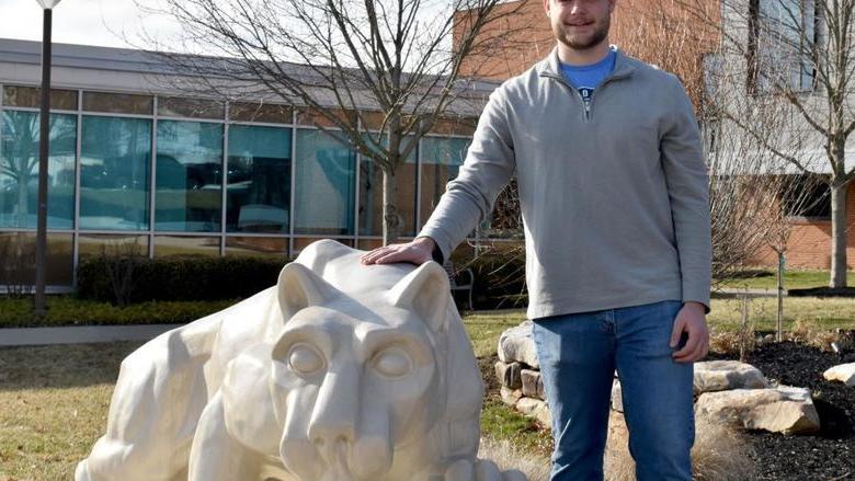 Dylan Treaster with the Lion Shrine on the campus of Penn State DuBois